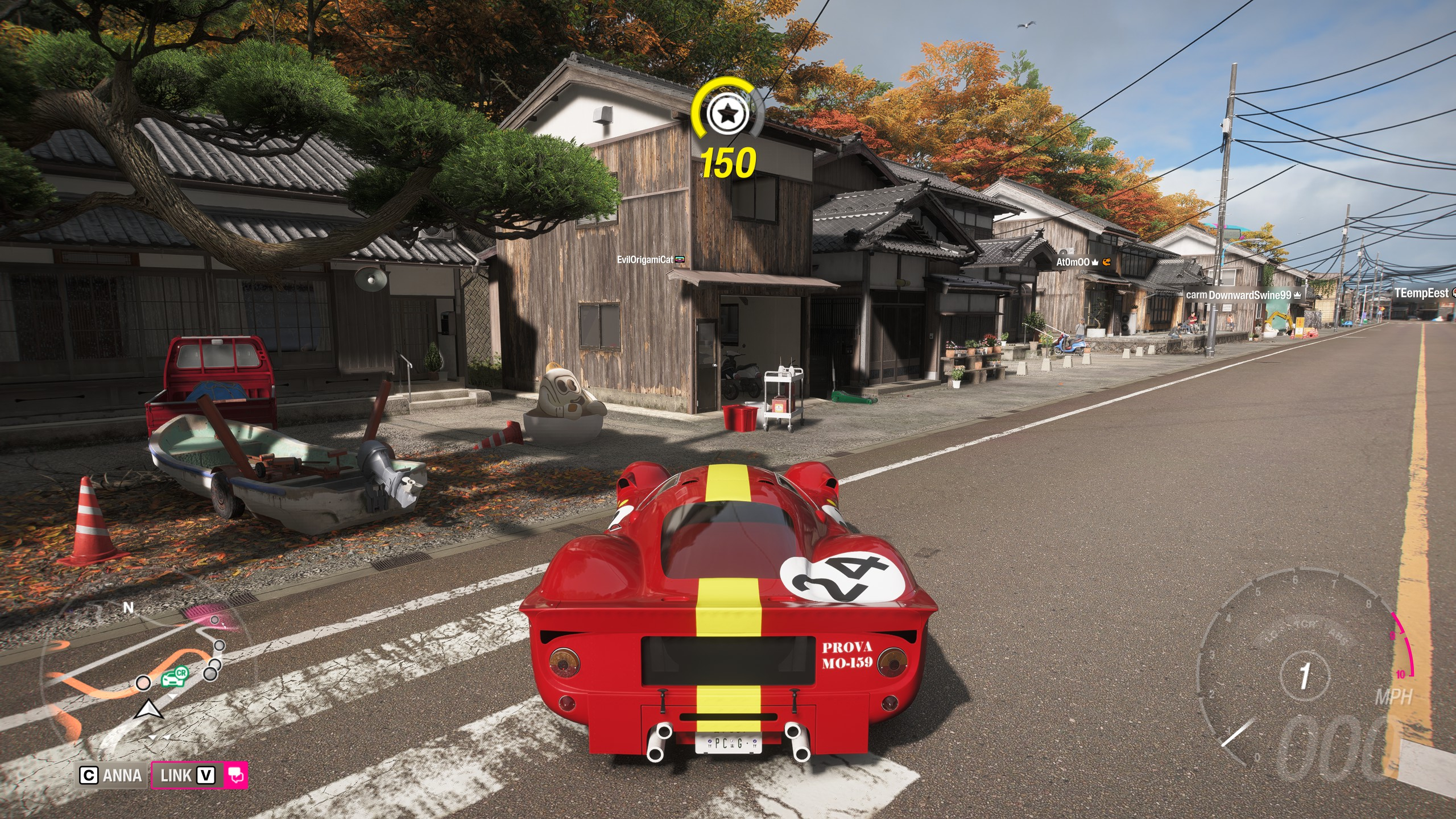 FH6 tank latte: A classic red Ferrari parked on a main road opposite a large latte mascot next to a house.