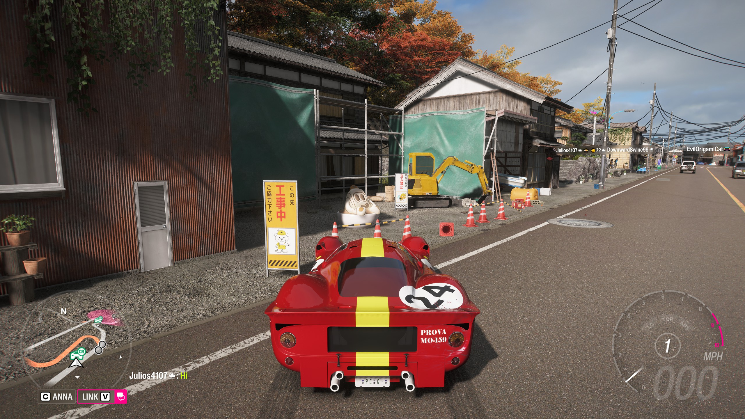 FH6 tank latte: A classic red Ferrari parked on a main road opposite a large latte mascot by a small building site.